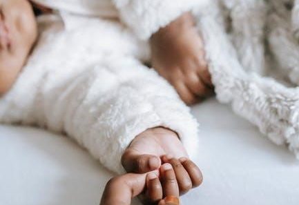 baby holding mom's hand