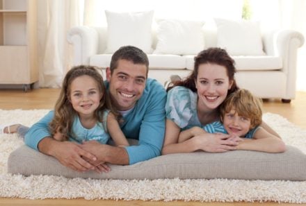 Adoption family laying on floor smiling