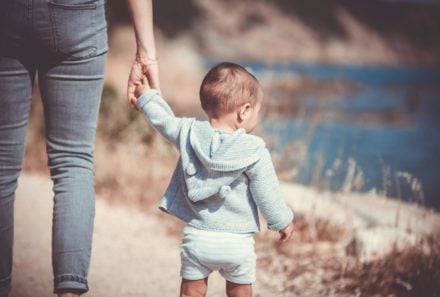 adopting a child baby holding mothers hand