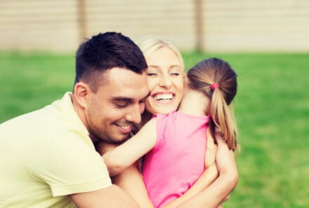 Happy family hugging each other