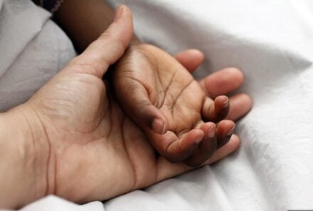 Mom holding child's hand