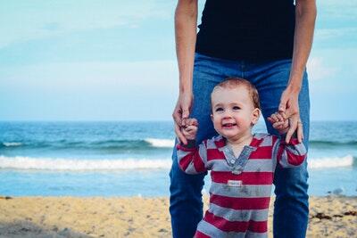 dad and young son walking on beach